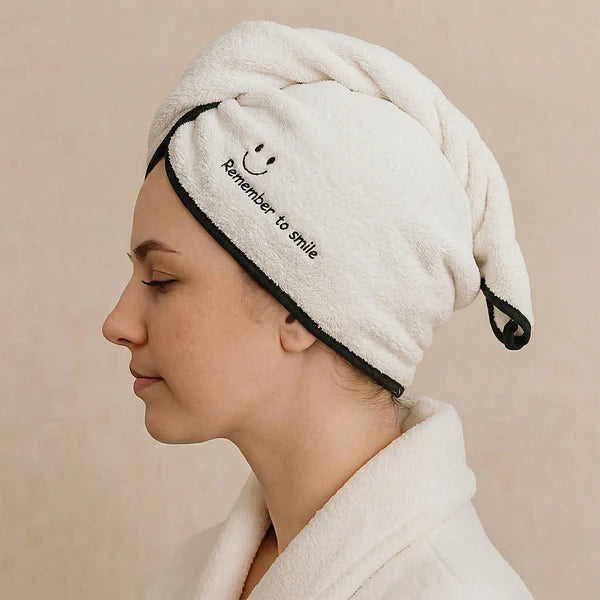 Woman adjusting microfiber hair wrap after shower